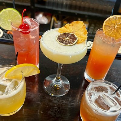 A spread of cocktails on the bar at The Dragon's Den