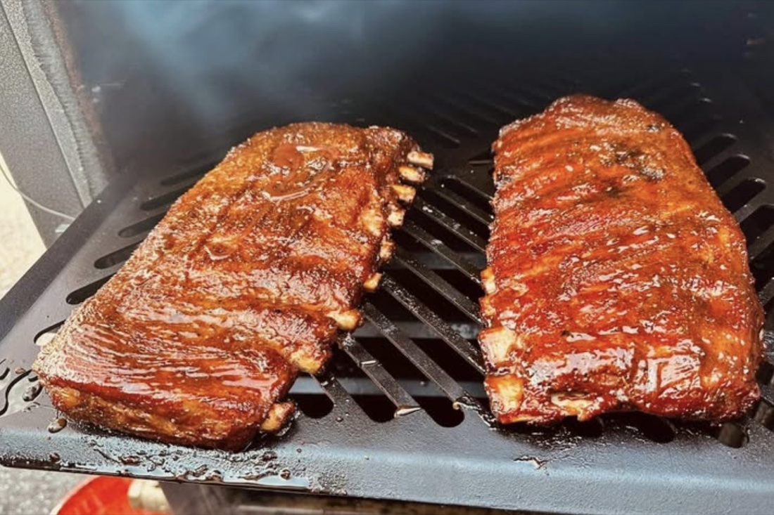 Two racks of spare ribs on the smoker